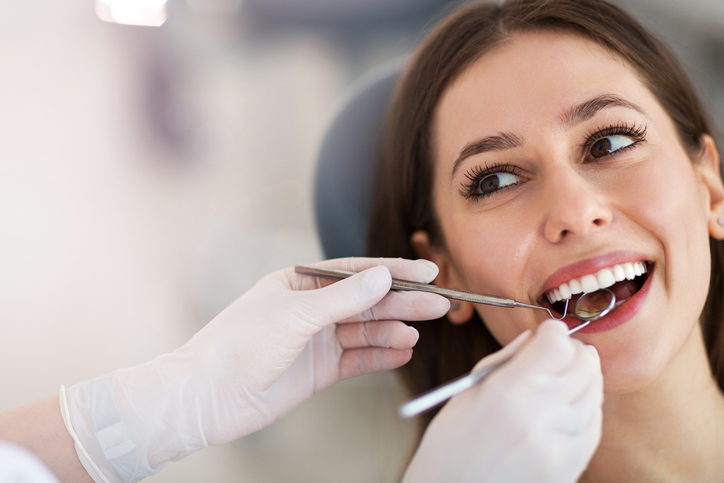 Woman having teeth examined at dentists